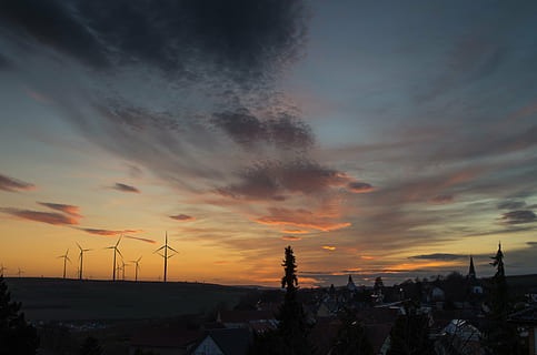 silhouette, windmills, golden, hour, wind, turbines, trees, dusk, windmill, structure, dark, sunset, houses, village, rooftops, tree, sky, clouds, built structure, architecture, cloud - sky, building exterior, no people, orange color, scenics, fuel and power generation, turbine, scenics - nature, wind turbine, nature, environment, beauty in nature, environmental conservation, renewable energy, alternative energy, wind power, outdoors, sustainable resources, power supply, 4K