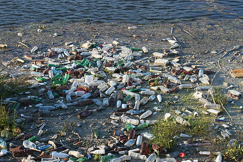 assorted-color-and-type bottle lot, bottles, dump, floating, garbage, plastic, pollution, river, rubbish, trash, water, man-made, nature, high angle view, environmental issues, day, beach, land, environment, sea, environmental damage, water pollution, outdoors, rock, no people, solid, dirty, pebble, 4K, CC0, public domain, royalty free