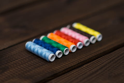 assorted-color threads, floor, multicolored, sewing, treads, thread, spools, string, colors, colours, multi colored, in a row, variation, no people, close-up, table, wood - material, choice, crayon, indoors, vibrant color, group of objects, selective focus, art and craft, pencil, focus on foreground, craft, creativity, writing instrument, order, arrangement, colored pencil, art and craft equipment, 2K, CC0, public domain, royalty free