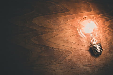 clear light bulb, light bulb, lightbulb, light, bulb, energy, electricity, light bulb idea, glow, invention, technology, innovation, conceptual, filament, creativity, creative, illumination, illuminate, bright, idea, electric, solution, imagination, glowing, think, electrical, create, creation, power, motivation, inspire, inspiration, lighting equipment, illuminated, no people, indoors, close-up, day, candle, high angle view, still life, light - natural phenomenon, wood - material, pen, table, electric lamp, fuel and power generation, 4K
