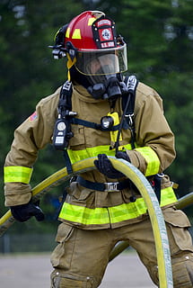 man, wearing, bunker suit, holding, hose, Firefighter, Fire, Portrait, Training, monitor, hot, heat, dangerous, burn, flames, smoke, water, equipment, helmet, rescue, military, fireman, protective Workwear, men, emergency Services, safety, work Helmet, danger, fire Protection Suit, firefighter's Helmet, protection, people, extinguishing, outdoors, uniform, one Person, headwear, risk, mid adult, sport, clothing, real people, day, security, accidents and disasters, occupation, nature, sports equipment, focus on foreground, rescue worker, obscured face, fire hose, 2K
