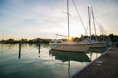 two, inline, white, sailboats, calm, body, water, cloudy, sky, daytime, sailing, boats, near, dock, still, items, things, yachts, pier, concrete, ocean, sea, clouds, nautical vessel, harbor, reflection, moored, no people, sailboat, mast, waterfront, transportation, mode of transportation, nature, cloud - sky, pole, sunlight, travel, beauty in nature, tranquility, outdoors, yacht, marina, luxury, anchored, 5K, CC0, public domain, royalty free