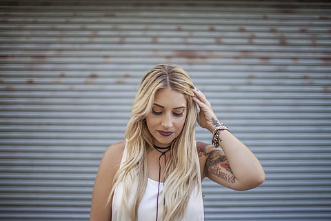 woman, standing, roller shutter, wearing, white, tank-top, holding, hair, women, blond Hair, one Person, adult, females, people, one Woman Only, young Adult, young Women, caucasian Ethnicity, one Young Woman Only, adults Only, copy Space, only Women, looking, lifestyles, emotional Stress, beauty, casual Clothing, front view, depression - sadness, hairstyle, long hair, portrait, wall - building feature, hand in hair, real people, leisure activity, beautiful woman, outdoors, 5K, CC0, public domain, royalty free