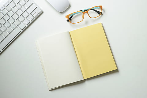 desk, laptop, notebook, table, blank, computer, eyewear, keyboard, mouse, pad, page, paper, technology, workplace, workspace, glasses, eyeglasses, book, publication, no people, wireless technology, indoors, communication, connection, business, copy space, note pad, studio shot, yellow, office, reading glasses, 4K, CC0, public domain, royalty free