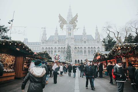 people, walking, street, near, brown, wooden, houses, architecture, building, infrastructure, sky, crowd, men, women, christmas, lights, decoration, bazaar, trade, tree, plant, winter, city, large group of people, city life, christmas decoration, day, built structure, building exterior, real people, travel destinations, lifestyles, group of people, tourism, adult, holiday, warm clothing, 5K
