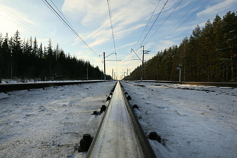 cold, outdoors, perspective, railroad, railway, snow, trees, winter, tree, transportation, sky, plant, track, rail transportation, railroad track, diminishing perspective, nature, electricity, the way forward, cable, cloud - sky, no people, direction, connection, technology, metal, day, power line, power supply, straight, surface level, 5K, CC0, public domain, royalty free