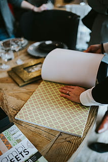photo frame, decorative, paper, table, Golden, gold, decoration, frame, photo, business, people, men, one person, indoors, one man only, human body part, adults only, human hand, real people, hand, selective focus, body part, pen, unrecognizable person, focus on foreground, lifestyles, sitting, occupation, high angle view, human limb, finger, 4K