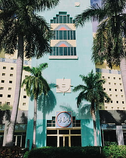 teal 404 bulding, front, yellow, building, teal, palm Tree, building Exterior, architecture, built Structure, uSA, urban Scene, hotel, clock, time, clock face, tree, tropical climate, plant, city, no people, nature, day, growth, outdoors, tree trunk, residential district, trunk, minute hand, 2K, CC0, public domain, royalty free