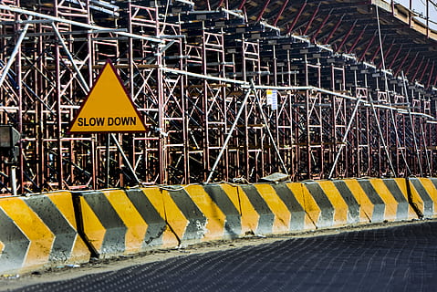 yellow, black, road, concrete, barrier, barriers, building, construction, danger, road construction, road sign, safety, sign, signage, slow down, steel, warning, warning sign, communication, text, western script, no people, architecture, transportation, day, guidance, built structure, information, railing, security, metal, protection, outdoors, warning symbol, 5K, CC0, public domain, royalty free