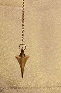 gold-colored pendulum, pendulum, commute, lot, cone, conical, metal, metal piece, tool, tools, vibrations, frequency, vibration frequency, pendulum vibrations, pendulum frequency, new age, spiritual, rest, position, resting position, brass, gold, instrument, gloss, hanging, gold colored, single object, no people, close-up, indoors, wall - building feature, necklace, celebration, studio shot, jewelry, chain, still life, textured, copy space, pendant, christmas, paper, ornate, 1080P, CC0, public domain, royalty free