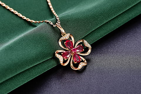embellished, gold, 4-leaf, clover, necklace, green, textile, Ruby, leaf, jewelry, pendant, close-up, green color, indoors, no people, food, freshness, still life, plant part, single object, high angle view, studio shot, shape, plant, directly above, tied up, focus on foreground, simplicity, personal accessory, 2K, CC0, public domain, royalty free