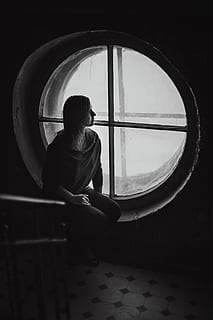 grayscale photography, woman, sitting, window, dark, room, round, black and white, people, girl, real people, one person, rear view, lifestyles, indoors, architecture, leisure activity, day, glass - material, circle, childhood, geometric shape, shape, women, men, transparent, contemplation, 5K, CC0, public domain, royalty free