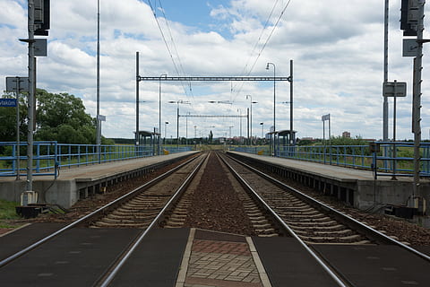 track, station, platform, stop, railway, transportation, railroad track, cloud - sky, sky, rail transportation, cable, electricity, diminishing perspective, power line, vanishing point, nature, direction, the way forward, day, connection, electricity pylon, no people, technology, built structure, outdoors, power supply, parallel, long, 5K, CC0, public domain, royalty free