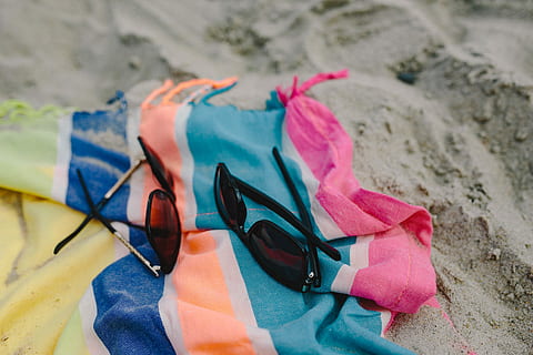 together, beach, sand, summer, blanket, holidays, vacations, sunglasses, clothing, beach Towel, sea, water, day, outdoors, land, close-up, shoe, glasses, focus on foreground, sandal, towel, nature, high angle view, fashion, no people, still life, selective focus, holiday, personal accessory, 4K, CC0, public domain, royalty free