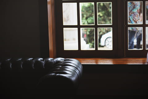 leather brown couch, tufted, black, leather sofa, brown, wooden, framed, window, inside, room, leather, sofa, dark room, settee, indoors, architecture And Buildings, no People, domestic Room, home Interior, day, close-up, glass - material, transparent, focus on foreground, seat, absence, table, nature, tree, furniture, wood - material, black color, 5K, CC0, public domain, royalty free