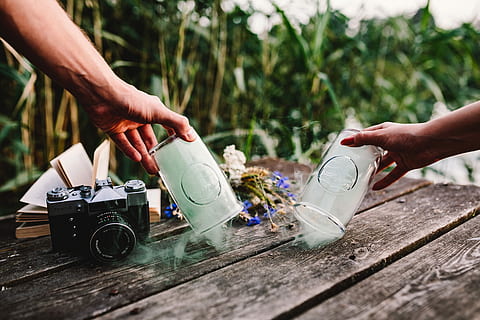 smoke bomb, book, vintage, camera, Colorful, wooden desk, wooden pier, fun, colorful smoke, outdoor, outdoors, people, shoe, men, one Person, human Leg, lifestyles, human Foot, males, copy Space, wood - Material, sport, human hand, human body part, two people, holding, day, hand, real people, body part, leisure activity, nature, focus on foreground, selective focus, arts culture and entertainment, pouring, finger, human limb, 4K