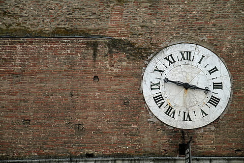 round, white, analog clock, wall, daytime, clock, wall clock, brick wall, old, roman, time, wall - building feature, brick, architecture, no people, circle, number, built structure, geometric shape, roman numeral, day, shape, building exterior, clock face, clock hand, minute hand, 5K, CC0, public domain, royalty free
