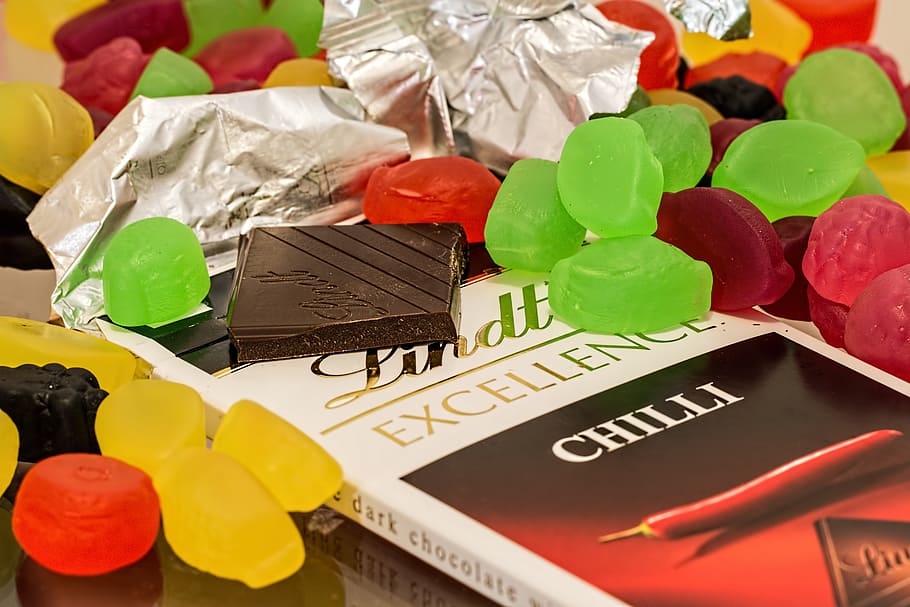 chocolate bar, chocolate, candy, sweets, sugar, cocoa, tasty, sugar rush, indulgence, dark chocolate, snack, sugar addiction, cacao, delicious, diabetes, unhealthy, confectionery, treat, calories, confection, colorful, diet, junk, celebration, sweet food, food, sweet, multi colored, food and drink, no people, close-up, dessert, indoors, text, large group of objects, unhealthy eating, finance, temptation, still life, red, 5K