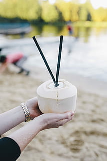 holding, fresh, coconut, Female, summer, fruit, holidays, vacations, fresh coconut, coconut water, juice, straw, coconut milk, outdoors, human Hand, nature, people, beach, relaxation, human body part, focus on foreground, hand, real people, one person, lifestyles, day, leisure activity, close-up, drink, water, food and drink, body part, personal perspective, finger, nail, human limb, 4K
