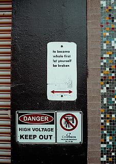 close-up, danger signage, black, wall, sign, left, right, warning, danger, communication, text, no people, western script, warning sign, script, wall - building feature, non-western script, architecture, built structure, information, day, information sign, building exterior, guidance, outdoors, metal, message, 720P