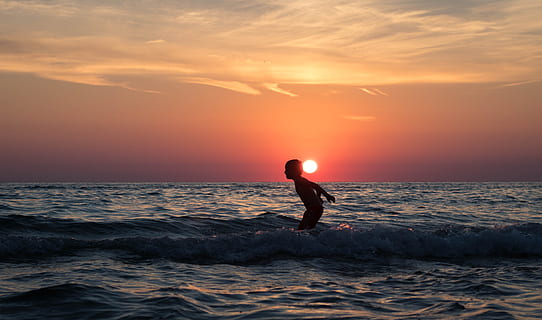sea, dawn, landscape, sky, beach, boy, clouds, dusk, evening, excitement, fun, horizon, ocean, outdoors, recreation, scenic, seascape, seashore, silhouette, splash, storm, summer, sun, sunset, water, waves, one person, horizon over water, motion, beauty in nature, nature, land, sport, wave, full length, lifestyles, scenics - nature, 5K, CC0, public domain, royalty free