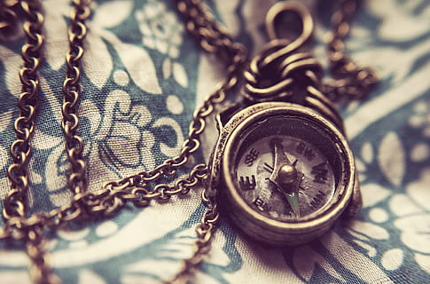 closeup, photo, round compass, compass, magnetic, orientation, navigation, chain, necklace, decorative, old, vintage, retro, direction, north, guidance, orienteering, symbol, instrument, arrow, macro, small, little, close-up, no people, wealth, pattern, metal, indoors, still life, selective focus, textile, focus on foreground, design, finance, full frame, jewelry, representation, currency, shape, high angle view, antique, pocket watch, floral pattern, silver colored, luxury, 4K, CC0, public domain, royalty free