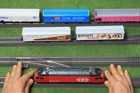 hands, art, industry, train, cargo containers, engineering, miniature toy, public transportation, railtrack, railway, technology, transportation system, travel, vehicle, human hand, hand, human body part, people, communication, holding, green color, text, personal perspective, day, nature, finger, human finger, arts culture and entertainment, grass, adult, music, real people, 4K, CC0, public domain, royalty free