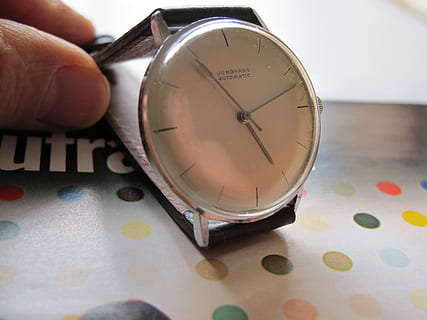 clock, junghans, automatic, time, indoors, number, close-up, human hand, hand, human body part, real people, shape, finger, geometric shape, circle, body part, one person, human finger, unrecognizable person, table, lifestyles, clock face, minute hand, 2K, CC0, public domain, royalty free