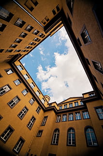 low-angle photography, yellow, concrete, building, low-angle shot photography, buildings, low angle, photography, brown, cloud, sky, architecture, atrium, window, building Exterior, urban Scene, built Structure, city, outdoors, architecture And Buildings, facade, no People, cloud - sky, low angle view, day, nature, residential district, glass - material, sunlight, apartment, in a row, directly below, 5K, CC0, public domain, royalty free