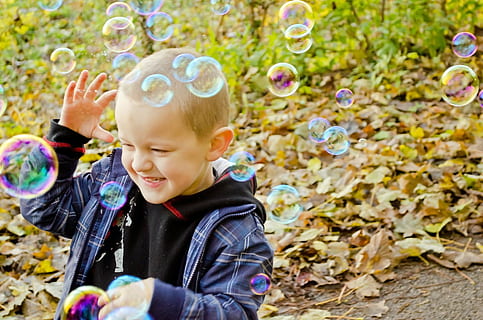 boy, plaid, zip-up jacket, playing, bubbles, bubble, fun, colors, game, flight, light, background, round, ball, circle, people, child, happy, children, kid, soap Sud, bubble Wand, blowing, outdoors, playful, childhood, nature, happiness, joy, cute, cheerful, small, one person, innocence, enjoyment, men, offspring, males, emotion, looking, boys, day, real people, 1080P, CC0, public domain, royalty free