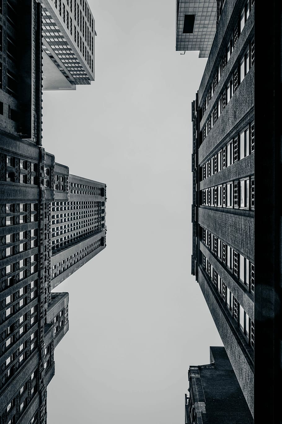 worm, eye view, city buildings, grayscale photography, buildings, building, skyscraper, tower, block, concrete, structure, building exterior, built structure, architecture, city, sky, no people, nature, tall - high, residential district, office building exterior, low angle view, day, outdoors, clear sky, office, directly below, window, place, location, financial district, 5K