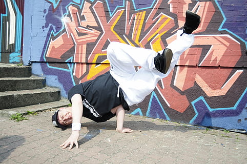 dance, body, breakdance, real people, full length, one person, lifestyles, leisure activity, day, architecture, built structure, graffiti, dancing, women, performance, wall - building feature, casual clothing, street, outdoors, front view, skill, young adult, obscured face, paving stone, 1080P, CC0, public domain, royalty free