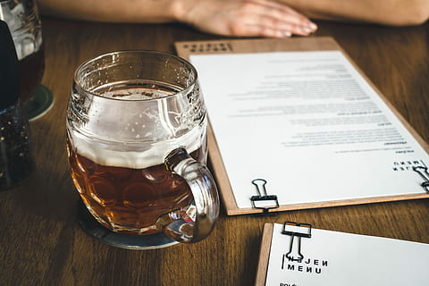 beer before meal, Beer, meal, drink, restaurant, wood, people, human Hand, men, table, document, one Person, indoors, human body part, close-up, food and drink, refreshment, paper, real people, wood - material, text, glass, drinking glass, transparent, high angle view, hand, freshness, glass - material, menu, finger, 5K
