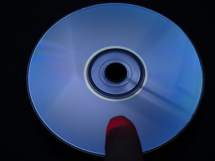 cd, dvd, digital, computer, silver, floppy disk, circle, geometric shape, shape, technology, close-up, human body part, body part, lens - optical instrument, reflection, blue, one person, studio shot, indoors, red, sky, lens - eye, personal perspective, camera - photographic equipment, black background, human foot, 2K, CC0, public domain, royalty free