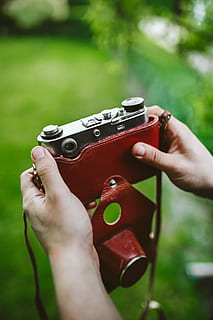 vintage black camera, Vintage, black, camera, old, photography, human Hand, outdoors, holding, people, one Person, camera - Photographic Equipment, human body part, music, playing, musical instrument, hand, real people, day, lifestyles, leisure activity, focus on foreground, unrecognizable person, body part, selective focus, finger, human finger, personal perspective, grass, close-up, 5K