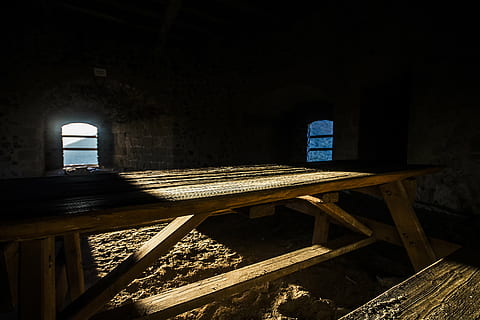 bricks, dark, picnic table, sand, shadow, sunlight, table bench, windows, wooden chair, wooden table, indoors, old, spooky, architecture, wood - material, nature, seat, built structure, no people, day, arch, table, bench, building, chair, religion, absence, history, empty, 2K, CC0, public domain, royalty free