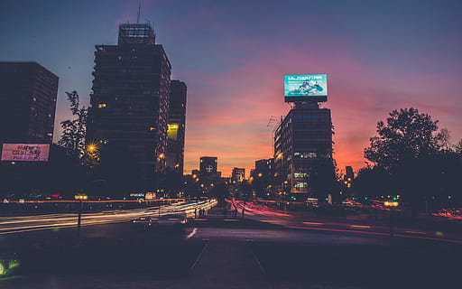 time-lapse photography, busy, road, city, building, structure, sky, infrastructure, window, establishment, hotel, urban, architecture, art, vehicles, cars, billboard, skyscraper, illuminated, night, dusk, building exterior, travel destinations, modern, built structure, street, transportation, office building exterior, sunset, tall - high, city life, nature, long exposure, no people, cityscape, light trail, city street, outdoors, financial district, light, 5K, CC0, public domain, royalty free