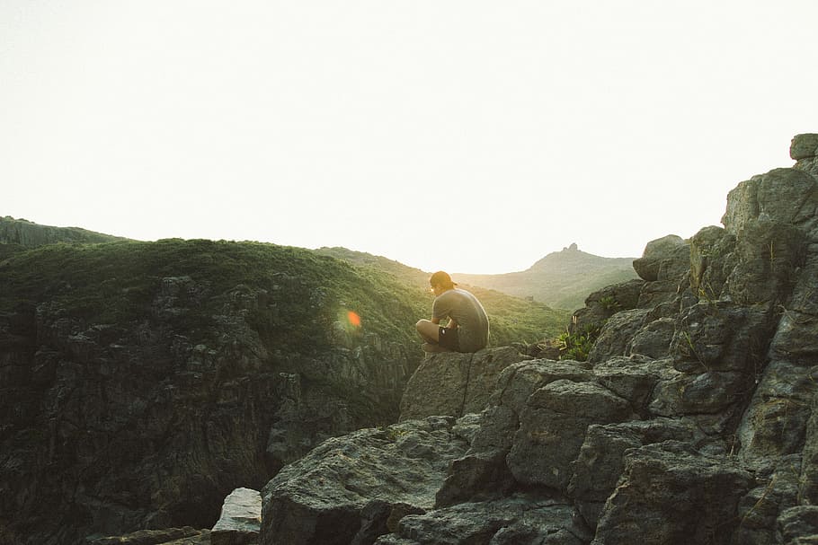 home, assegut, penya-segat, sortida del sol, persona, rock, vora, muntanya, posta de sol, sol, pensar, aventura, seure, sittin, paio, masculí, pedra, trek, sòlid, rock - object, cel, naturalesa, bellesa a la natura, cel clar, formació de roca, còpia espai, escenics - natura, dia, una persona, escena tranquil·la, tranquil·litat, a l'aire lliure, flare de la lent, llum solar, activitat d'oci, 5K
