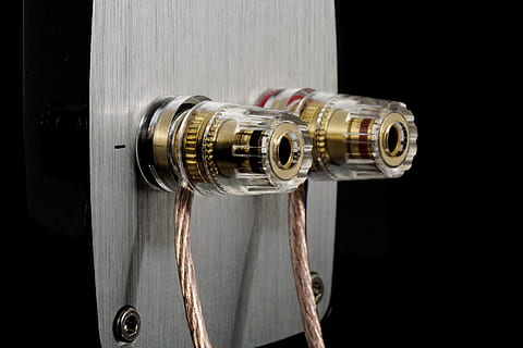 closeup, photo, cylindrical, gold-colored part, gray, board, speakers, connection, speaker cable, cable, audio, music, sound, jam, current, voltage, performance, close-up, security, technology, metal, indoors, no people, protection, black background, safety, security system, photography themes, camera - photographic equipment, single object, wood - material, studio shot, lens - optical instrument, lens - eye, equipment, lock, rope, 2K, CC0, public domain, royalty free