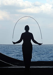 woman, holding, jump rope, sea, ocean, water, ship, aircraft carrier, navy, military, sailor, jumping rope, exercising, exercise, sky, clouds, silhouette, outside, standing, real people, cloud - sky, one person, horizon over water, leisure activity, horizon, scenics - nature, rear view, lifestyles, beauty in nature, nature, three quarter length, day, outdoors, human arm, looking at view, 1080P, CC0, public domain, royalty free