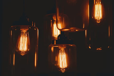 amber glass lamps, four, dimmed, light bulbs, halogen, laps, turned on, inside, dim, room, light, dark, bulb, glow, lightbulb, fire - Natural Phenomenon, lighting Equipment, heat - Temperature, night, flame, light - Natural Phenomenon, illuminated, glowing, candle, indoors, jar, no people, container, glass - material, transparent, close-up, bottle, still life, fire, food and drink, glass, burning, in a row, nature, black background, 4K, CC0, public domain, royalty free