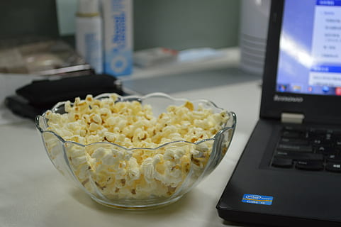 popcorn, computer, desk, technology, indoors, food, computer monitor, food and drink, desktop pc, computer keyboard, close-up, no people, computer equipment, table, communication, keyboard, connection, wireless technology, furniture, focus on foreground, business, snack, 2K, CC0, public domain, royalty free