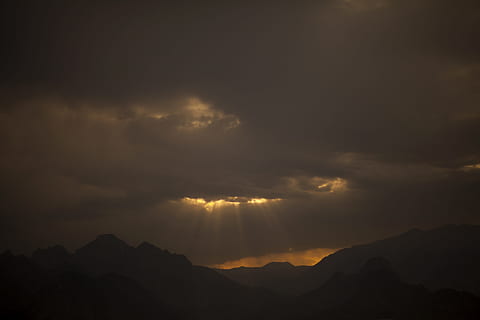 silhouette photography, mountains, clouds, landscape, mountain, cloud, sky, nature, light, high, peace, background, beautiful, open air, yellow, solar, autumn, outdoor, season, photo, emotional, photography, spring, panoramic, summer, travel, sunset, romantic, colorful, pictures, beauty, environmental, beauty in nature, cloud - sky, scenics - nature, tranquility, tranquil scene, mountain range, silhouette, idyllic, no people, majestic, dramatic sky, awe, environment, storm, sunbeam, outdoors, dark, mountain peak, ominous, 5K, CC0, public domain, royalty free