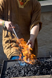 forge, craft, fire, iron, embers, hammer, art, glow, hot, blacksmith, metal, bending, burned, middle ages, work, anvil, form, hand, workshop, burning, real people, fire - natural phenomenon, heat - temperature, one person, flame, holding, midsection, men, nature, day, lifestyles, human hand, preparation, smoke - physical structure, outdoors, occupation, preparing food, 2K, CC0, public domain, royalty free