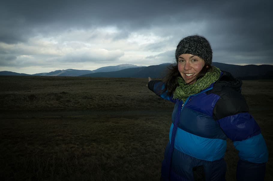 cold, landscape, mountains, nature, cloudy, daylight, environment, evening, gloomy, high, hiker, mountain climber, mountain peak, mountain range, outdoor, person, pointing, scenic, sky, trekking, view, cloud - sky, mountain, clothing, one person, adult, land, scenics - nature, young adult, standing, leisure activity, smiling, winter, women, portrait, warm clothing, outdoors, 4K