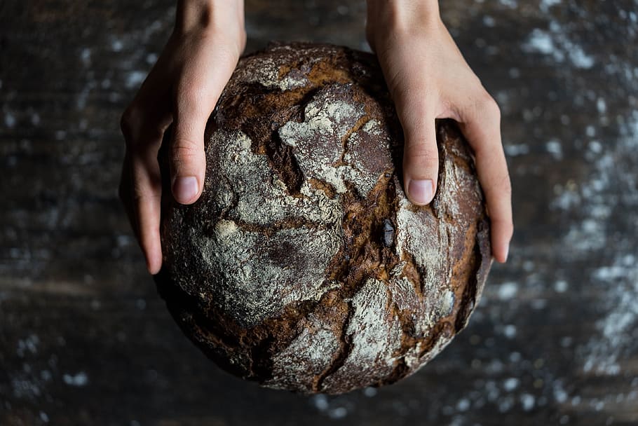 human, holding, brown, fruit, baked, baker, ball-shaped, blur, bread, close-up, dark, environment, food, hands, indoors, person, wood, human hand, hand, one person, human body part, nature, solid, high angle view, focus on foreground, body part, textured, day, flour, food and drink, finger, 4K