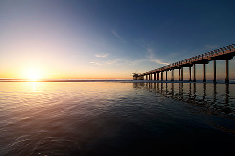 brown, wooden, dock, calm, body, water, daytime, nature, beach, shore, sand, bridge, ocean, sea, reflection, light, sunset, bridge - man made structure, sky, tranquility, sunlight, scenics, tranquil scene, architecture, built structure, connection, scenics - nature, transportation, no people, horizon, sun, blue, horizon over water, outdoors, architectural column, 4K