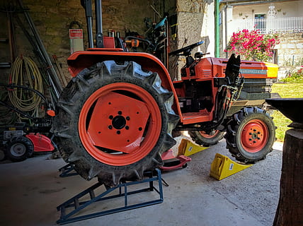 home workshop, tractor, elevator, transportation, wheel, mode of transportation, architecture, land vehicle, building exterior, day, built structure, no people, city, tire, outdoors, street, agricultural equipment, red, agricultural machinery, truck, motor vehicle, 4K, CC0, public domain, royalty free