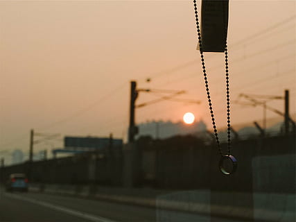 silver-colored necklace, hanging, inside, car front windshield, selective, photo, ring, pendant, necklace, beads, windshield, driving, road, sunset, sky, transportation, outdoors, city, building exterior, no people, architecture, close-up, street, dusk, illuminated, lighting equipment, nature, built structure, focus on foreground, street light, night, 1080P, CC0, public domain, royalty free