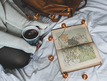 almanac book, white, textile, map, atlas, lights, string lights, hand, drink, cup, mug, refreshment, indoors, food and drink, book, publication, coffee, coffee - drink, high angle view, coffee cup, bed, furniture, no people, still life, table, directly above, tea, hot drink, floral pattern, 4K, CC0, public domain, royalty free